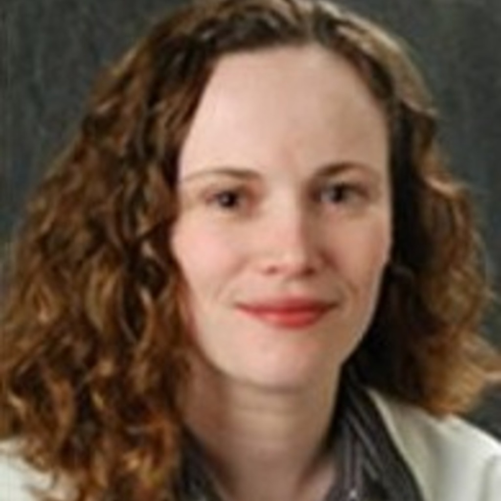 A photo of Dr. Natalie Denburg wearing a white coat